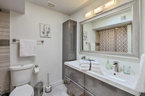 a bathroom with a sink and a toilet and a mirror at Chic Scottsdale Home with Balcony, Walk to Old Town! in Scottsdale