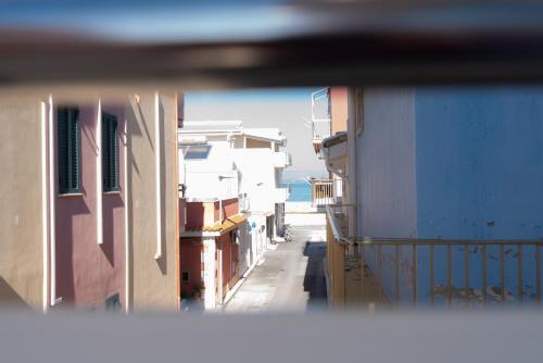 a view of a building from a side view mirror at Stella Maris Marzamemi Apartments in Marzamemi
