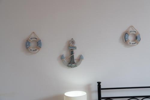 a room with three anchors on a white wall at Stella Maris Marzamemi Apartments in Marzamemi