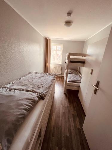 a bedroom with a bed and a bunk bed at Ferienwohnung Strandeck - Inklusive Strandkorb in den Sommermonaten in Göhren
