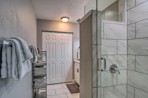 a bathroom with a walk in shower and a glass door at Bright Venice Getaway Less Than 1 Mi to Historic Dtwn in Venice