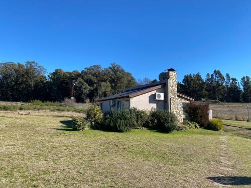 a small house in the middle of a field at Las Calandrias de Tandil in Tandil