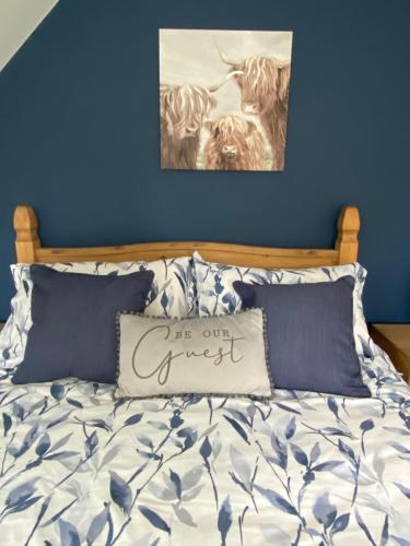 a bed with a pillow with the words off our guest at Attic views in Caol