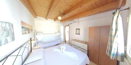 a small room with a bed and a staircase at Stella Maris Marzamemi Apartments in Marzamemi