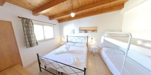 a bedroom with two bunk beds and a window at Stella Maris Marzamemi Apartments in Marzamemi