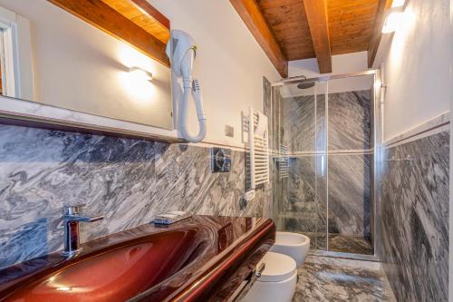 a bathroom with a sink and a shower at Piccola Venezia Room in Chioggia