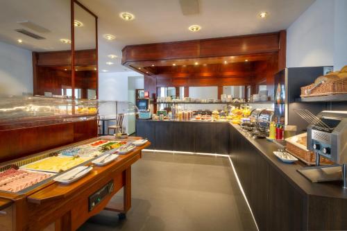 a kitchen with a lot of food on the counter at Hotel Harmony in Prague