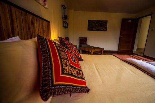 a bed with two pillows on top of it at ISKAY BOUTIQUE HOSTEL in La Paz