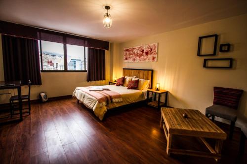 a hotel room with a bed and a table at ISKAY BOUTIQUE HOSTEL in La Paz