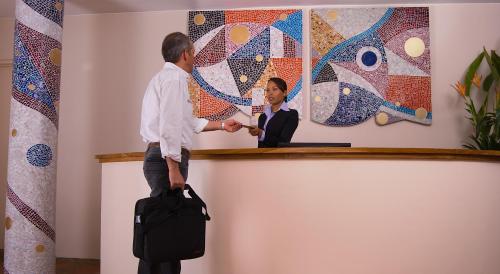 a man shaking hands with a woman at a podium at Hotel Casa Deco in Bogotá
