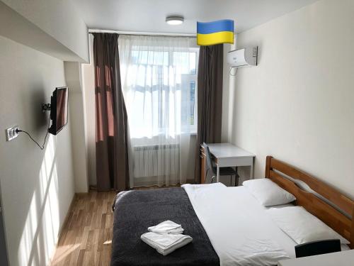 a hotel room with a bed and a window at Apartmant in Kyiv for you in Kyiv