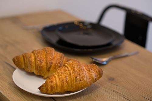 two croissants sitting on a plate on a table at Aju Hillel 14 in Jerusalem