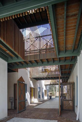 awning over a walkway in a building with a patio at The Iris in Charleston