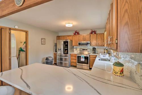 a kitchen with a white counter top and wooden cabinets at about 1 Mi to Lake Secluded Poconos Home with Decks in Jim Thorpe