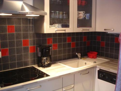 a kitchen with a sink and a coffee maker at Les Lutins for 4 persons. near the sea. in Commes