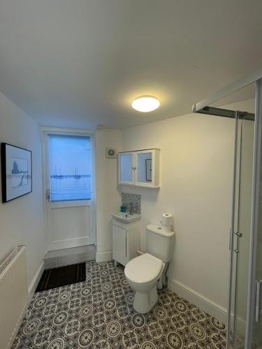 a bathroom with a toilet and a window at Huge 6 Bedroom House in Sheringham in Sheringham