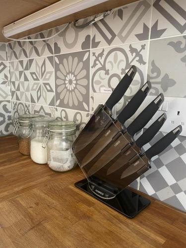 a bunch of knives in a holder on a kitchen counter at Huge 6 Bedroom House in Sheringham in Sheringham