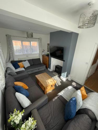 a living room with a couch and a tv at Huge 6 Bedroom House in Sheringham in Sheringham