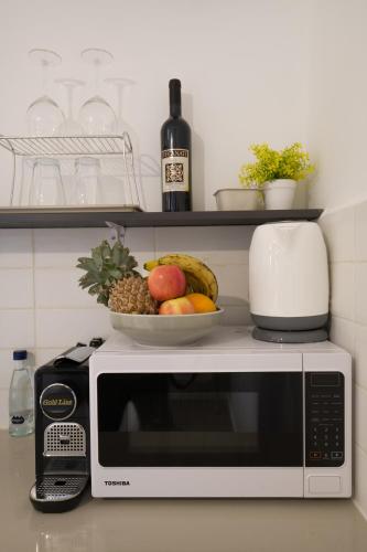 a microwave with a bowl of fruit on top of it at Aju Hillel 14 in Jerusalem
