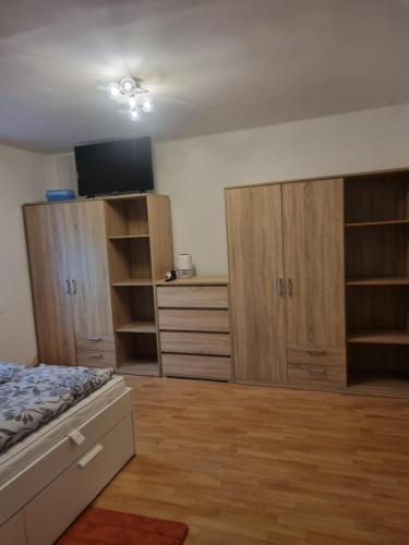 an empty bedroom with wooden cabinets and a bed at FeWo Teusch Top4 in Arnoldstein