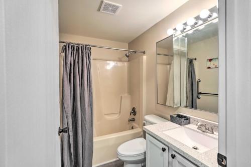 a bathroom with a toilet and a sink and a mirror at Renovated Home with Deck, Steps to State Park! in Ottawa
