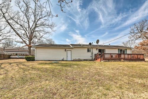 a white house with a porch on a yard at Renovated Home with Deck, Steps to State Park! in Ottawa