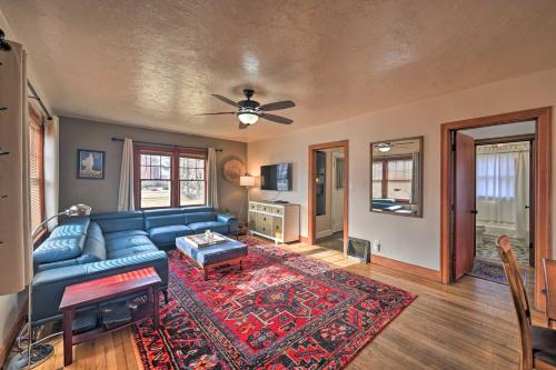 a living room with a blue couch and a rug at Charming Missoula House Near Downtown and UM! in Missoula