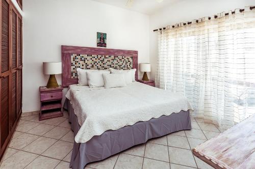 מיטה או מיטות בחדר ב-Fabiola Condo Hotel