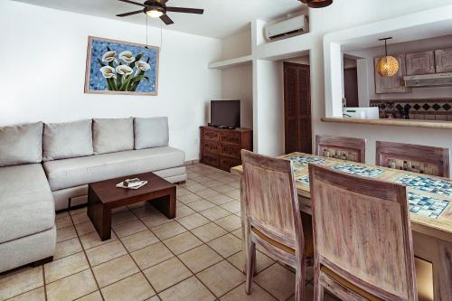 a living room with a couch and a table at Fabiola Condo Hotel in Playa del Carmen