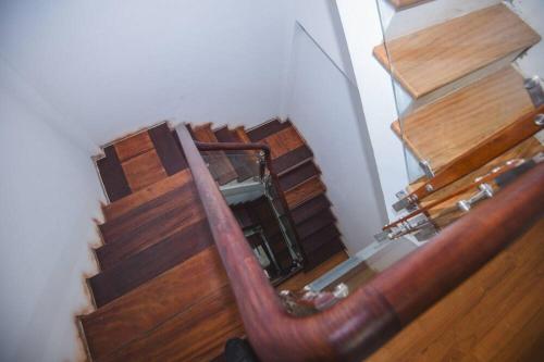 an overhead view of a wooden stairs with a mirror at Old Town Palace Guest House in Hanoi