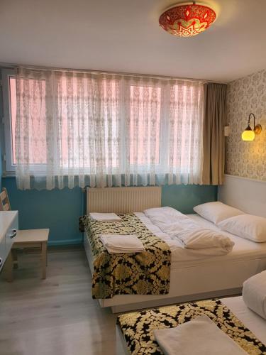 A bed or beds in a room at Tulip Guesthouse