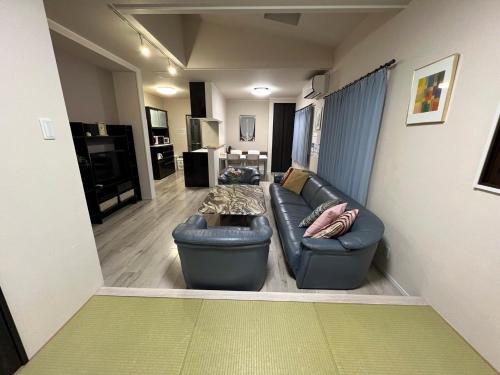 a living room with a couch and a table at Nara Guesthouse Kaede in Nara