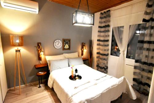 a bedroom with a white bed and a window at Casa Katina , villa in Lagana, Agrilia area in Laganas