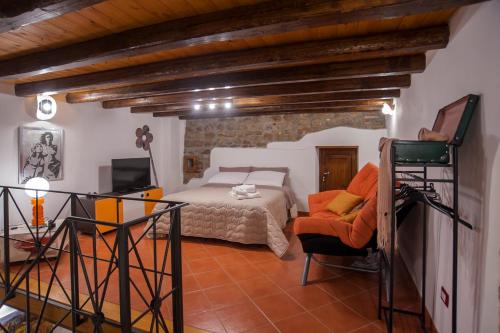 a bedroom with a bed and a chair in a room at Mirose's holiday home in Castelbuono