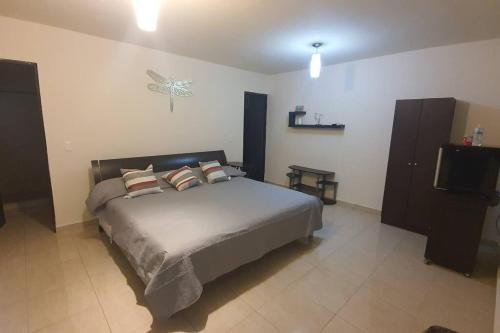 a bedroom with a bed with two pillows on it at DEPARTAMENTO NUEVO Y CENTRICO EN MITRAS NORTE in Monterrey