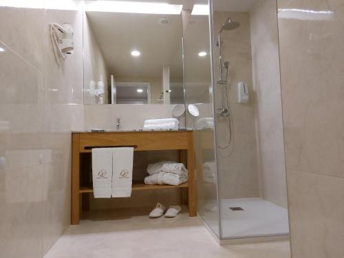 a bathroom with a shower and a sink at Quinta da Roda Hotel - Conforto e Tranquilidade no Gerês in Cela