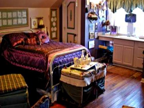 a bedroom with a bed and a table in it at Ducote-Williams House in Abbeville