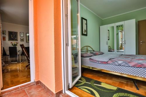 a room with a bed and a glass door at Apartment Sole in Cetinje