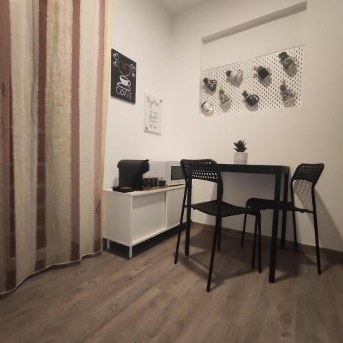 a table and two chairs in a room at Family House in Vila do Bispo