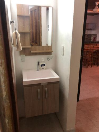 a bathroom with a sink and a mirror at Jamadis in Tolú