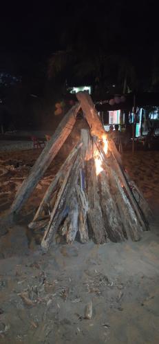 a pile of wood on the beach at night at Jamadis in Tolú