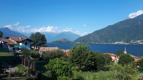 a town with a lake and mountains in the background at AnMa Cottages The Secret Garden in Pianello Del Lario