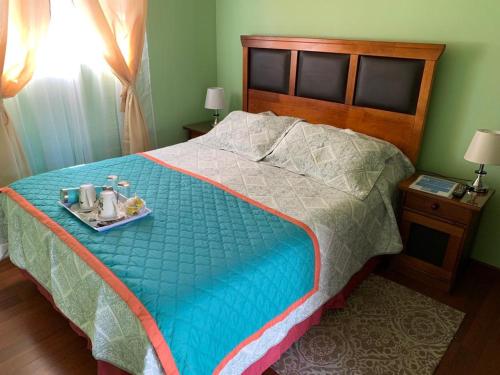 a bedroom with a bed with a tray of food on it at Hospedaje La ruta Los Angeles in Los Ángeles