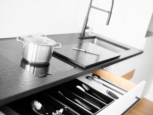 a kitchen counter with a pot on a sink at livisit bergapartments in Stuttgart