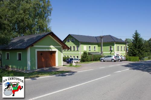 a house with a christmas sign on the side of the road at Penzion na Čertovce in Dolní Orlice