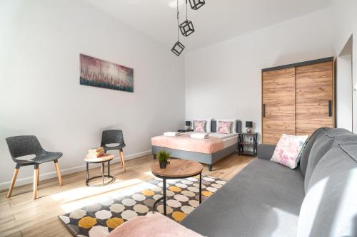 a living room with a couch and a table at MARGI Eos Apartament LARGE & BALCONY in Szczecin