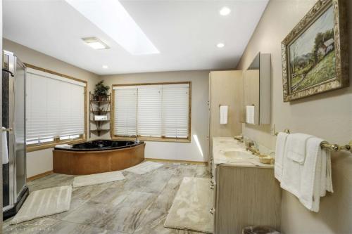 a bathroom with a tub and a sink at 18802 - 2 Granada Way in Hot Springs Village