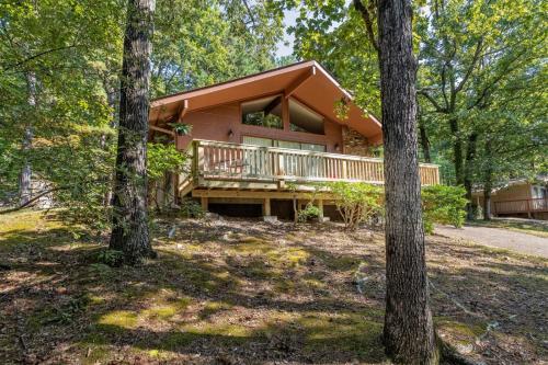 a house in the woods with a deck at 05210 - 8 South Pego Way in Hot Springs Village