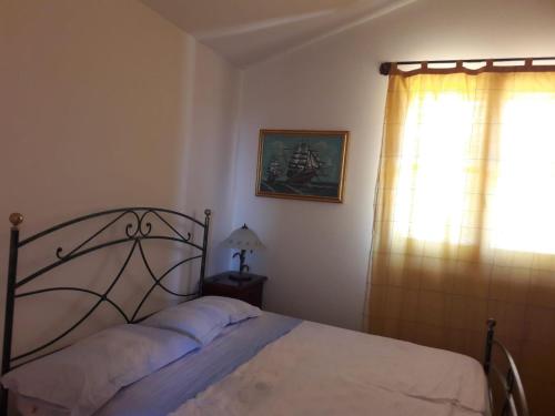 Ένα ή περισσότερα κρεβάτια σε δωμάτιο στο Villetta Santa Maria al Bagno