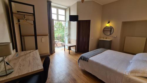 a bedroom with a bed and a table and a window at Il Sole in Bergamo